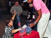 Fort Campbell, KY - Catherine Walker, manager of Fort Campbell Morale, Welfare and Recreation’s The Zone and hostess of The Zone’s 2012 Superbowl party, hands out prizes to Soldiers from Fort Campbell. (U.S. Army photo by Sgt. Joe Padula, 2nd BCT PAO, 101st Abn. Div.