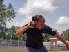 Sgt. Kadina Baldwin heaves a heavy shot put ball July 1, 2014 at Fort Campbell?s Fryar Stadium, demonstrating the winning technique she used during the Army Warrior Games trials June 15-20 at the U.S. Military Academy, West Point, New York. Baldwin took the bronze medal in shot put and gold medals in wheelchair basketball and sitting volleyball.  (U.S. Army photo by Stacy Rzepka/RELEASED)