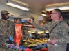 Command Sgt. Maj. Christopher T. Crawford, the 101st Special Troops Battalion command sergeant major, gives Spc. Victor W. Stephans, a mechanic with Task Force Lifeliner, his tray of food while serving lunch at the Koele Dining Facility during Thanksgiving Day, Nov. 28, 2013, at Bagram Air Field, Parwan province, Afghanistan. The Task Force Lifeliner Soldiers had the opportunity to enjoy a bountiful traditional holiday meal. (U.S. Army photo by Sgt. Sinthia Rosario, Task Force Lifeliner Public Affairs)