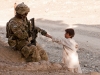 U.S. Army Sgt. Clarence Davis, a forward observer attached to Blue Platoon, Troop B, 1st Squadron, 33rd Calvary Regiment, 3rd Brigade Combat Team, 101st Airborne Division (Air Assault), gives an Afghan boy a pen in Shamal District, Oct. 26, 2012. Part of Troop B’s mission was to gather intelligence by engaging the local populace. (U.S Army photo by Sgt. Christopher Bonebrake, 115th Mobile Public Affairs Detachment)