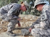 U.S. Army Staff Sgt. Sabrina Lindahl of Oroville, CA, 230th Military Police Company, Task Force Bastogne, riles up Doly, a patrol narcotics detector dog from Naval Air Station in Jacksonville, FL, for bite-sleeve training at Forward Operating Base Fenty here August 13th. Doly assists U.S. Navy Master-at-Arms Petty Officer 2nd Class Rodney Ericson of Anchorage, AL, locate any narcotics or contraban that soldiers or Afghan civilians might possess. (Photo by U.S. Army Spc. Richard Daniels Jr., Task Force Bastogne Public Affairs)