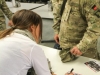 Grammy award winning song writer Hillary Lindsey signs an autograph for Sgt. Brian Fogarty, a soldier assigned to Headquarters Troop, 1st Squadron, 33rd Cavalry Regiment, 3rd Brigade Combat Team \"Rakkasans,\" 101st Airborne Division (Air Assault), during an autograph session by the Nashville to You Tour at Camp Clark, Nov. 15, 2012. The tour featured Nashville\'s top songwriters and performers as they traveled throughout Afghanistan performing for deployed soldiers. (U.S. Army Photo by Sgt. 1st Class Abram Pinnington, TF 3/101 PAO)