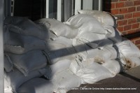 Sandbags stacked at the entrance to a business on Riverside Drive.