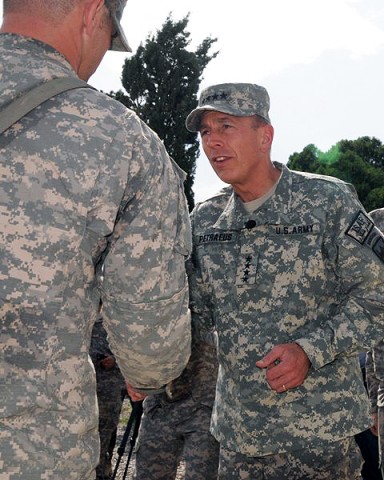 U.S. Army Gen. David H. Petraeus, shakes hands with a Soldier from the 3rd Brigade, 101st Airborne Division during a brief visit at Forward Operating Base Salerno Aug. 19th. Petraeus presented commander’s coins to Soldiers who have more than 36-months of deployed time.  (Photo by U.S. Army Sgt. Brent C. Powell, 3rd Brigade, 101st Airborne Division)