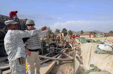 U.S. Army 1st Sgt. Eric Davis, base operations mayor for Forward Operating Base Salerno and company first sergeant for Headquarters and Headquarters Company, 3rd Brigade, 101st Airborne Division, talks with Bobby Rampy, a Fluor site safety manager from Magnolia, Texas, Sept. 24th about what actions to take to repair a leaking fuel storage tank at FOB Salerno. Davis is a native of Grand Rapids, MI. (Photo by U.S. Army Sgt. Brent C. Powell, 3rd Brigade, 101st Airborne Division)