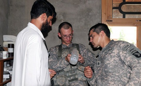 From center, U.S. Army Spc. Asa U. Holm of Cassville, Mo., a medic, and U.S. Army 1st Lt. James D. Horne of Fayetteville, NC, a platoon leader, both with Company A, 2nd Battalion, 327th Infantry Regiment, Task Force No Slack, examine the medical supplies available to the clinic at the village of Lar Sholtan village in eastern Afghanistan's Kunar province. The unit made arrangements to provide the clinic with its spare medical supplies.  (Photo by U.S. Army Staff Sgt. Gary A. Witte, 300th Mobile Public Affairs Detachment)