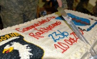 A Soldier from Task Force Rakkasan cuts the t cake at the “10-10-10” re-enlistment ceremony at Forward Operating Base Salerno, Khowst Province, Afghanistan Oct. 10th. The Rakkasans reenlisted 236 Soldiers, one to mark each year the U.S. Army has been in existence. (U.S. Army Photo by Maj. S. Justin Platt, 3rd Brigade Combat Team Public Affairs)