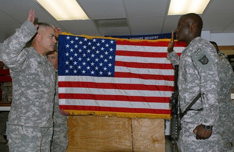 U.S. Army Maj. Gen. John Campbell, 101st Airborne Division commander, re-enlists U.S. Army Spc. Anthony Oniyelu, Headquarters and Headquarters Company, 3rd Brigade Combat Team, 101st Airborne Division, from Miami, during a mass re-enlistment ceremony consisting of 236 Rakkasan Soldiers Oct. 10th. (U.S. Army Photo by Pfc. Chris McKenna, 3rd Brigade Combat Team Public Affairs)