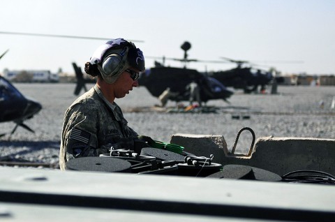 Spc. Kimberly Brooke Jones, E Troop, Task Force Saber ammunition specialist loads the rocket pod of an OH-58D Kiowa Warrior as a heavy weapons team lands for fuel and ammunition Nov. 29th, 2010. (Photo by Spc. Tracy Weeden)