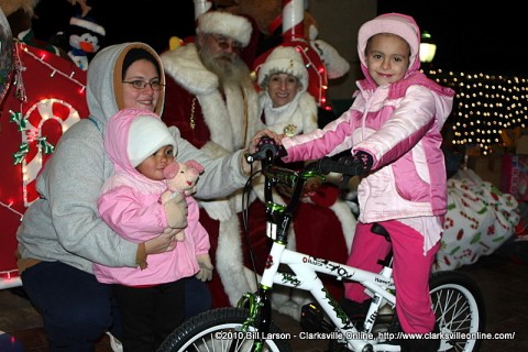 A young girl visiting with Santa Claus at Christmas on the Cumberland received a brand new bicycle for Christmas