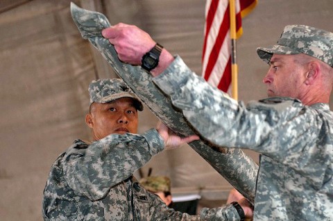 U.S. Army Col. Viet Luong, commander of the 3rd Brigade Combat Team, 101st Airborne Division, Task Force Rakkasan, and a resident of Fort Campbell, KY, and U.S. Army Command Sgt. Maj. Gregory Patton, a resident of Fort Campbell, KY, case their brigade colors for the transfer of authority ceremony held at Forward Operating Base Salerno in Khowst Province Jan. 30th.  (Photo by U.S. Army Spc. Tobey White, Task Force Duke Public Affairs)