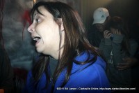 A frightened woman heads out of a room in the Bikers Who Scare Haunted House