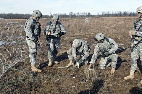 Soldiers of the 1st Special Troops Battalion, 1st Brigade Combat Team, 101st Airborne Division, detonate a bangelore torpedo to destroy concertina wire during a training scenario here at the range Dec. 9th. (Photo by Sgt. Richard Daniels Jr.)
