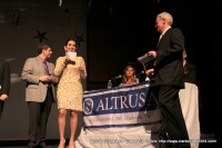 Henry Martin from Stone, Rudolph, and Martin CPAs presents the winners to hosts Cydney Miller and Rick Marino