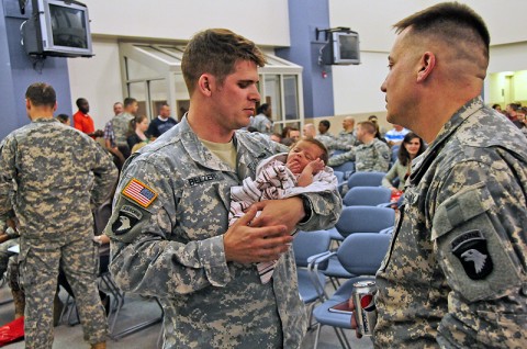 Capt. Daniel Belzer, one of the deploying Security Force Assistance Team members with the 2nd Brigade Combat Team, 101st Airborne Division (Air Assault), holds his newly born child during the brigade’s pre-deployment brief held March 6th. The brief provided information and guidance to the family members and Soldiers regarding the upcoming Strike SFAT deployment to Afghanistan. (U.S. Army photo by Sgt. Joe Padula, 2nd BCT PAO, 101st Abn. Div.)