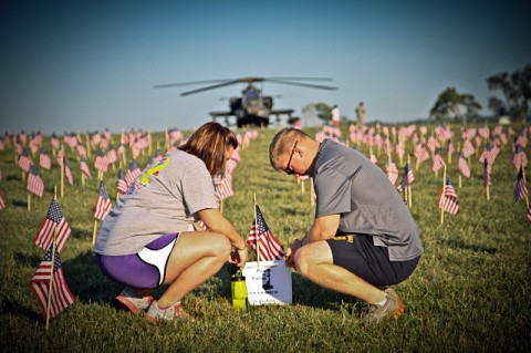 Michelle Leibold, wife of Spc. Jeff Leibold, an infantryman with Headquarters and Headquarters Company, 2nd Brigade Combat Team, 101st Airborne Division (Air Assault), pay their respects to a fallen comrade during the Run for the Fallen Aug. 11th. (U.S. Army photo by Sgt. Joe Padula, 2nd BCT PAO, 101st ABN.DIV)
