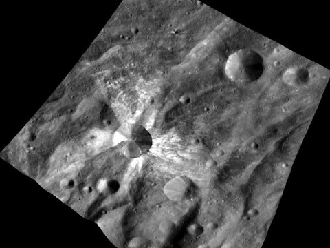 This image from NASA's Dawn spacecraft features the distinctive crater Canuleia on the giant asteroid Vesta. Canuleia, about 6 miles (10 kilometers) in diameter, is distinguished by the rays of bright material that streak out from it. (Image credit: NASA/JPL-Caltech/UCLA/MPS/DLR/PSI/Brown)