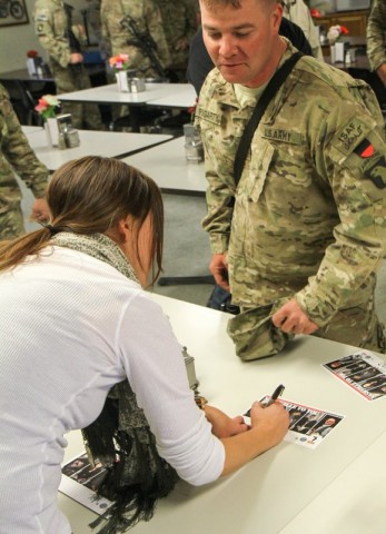 Grammy award winning song writer Hillary Lindsey signs an autograph for Sgt. Brian Fogarty, a soldier assigned to Headquarters Troop, 1st Squadron, 33rd Cavalry Regiment, 3rd Brigade Combat Team "Rakkasans," 101st Airborne Division (Air Assault), during an autograph session by the Nashville to You Tour at Camp Clark, Nov. 15, 2012. The tour featured Nashville's top songwriters and performers as they traveled throughout Afghanistan performing for deployed soldiers. (U.S. Army Photo by Sgt. 1st Class Abram Pinnington, TF 3/101 PAO)