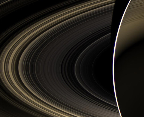 Peering over the shoulder of giant Saturn, through its rings, and across interplanetary space, NASA's Cassini spacecraft spies the bright, cloudy terrestrial planet, Venus. The vast distance from Saturn means that Venus only shows up as a white dot, just above and to the right of the image center. (Image credit: NASA/JPL-Caltech/Space Science Institute)