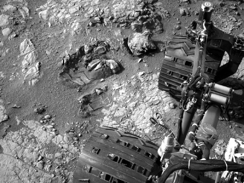This view of Curiosity's left-front and left-center wheels and of marks made by wheels on the ground in the "Yellowknife Bay" area comes from one of six cameras used on Mars for the first time more than six months after the rover landed. The left Navigation Camera (Navcam) linked to Curiosity's B-side computer took this image during the 223rd Martian day, or sol, of Curiosity's work on Mars (March 22, 2013). The wheels are 20 inches (50 centimeters) in diameter. (Image credit: NASA/JPL-Caltech)