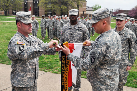 Command Sgt. Maj. Brandon Haywood, command sergeant major of the 2nd Brigade Combat Team, 101st Airborne Division (left), and 101st Airborne Division Senior Acting Commander, Brig. Gen. Mark Stammer, add the coveted Gold Air Assault Excellence Streamer to the Apache Troop, 1st Squadron, 75th Cavalry Regiment, 2nd Brigade Combat Team, 101st Airborne Division (Air Assault) guidon during a special ceremony conducted at Strike Field Tuesday. (Photo by Master Sgt. Pete Mayes, 101st Airborne Division Public Affairs Office)