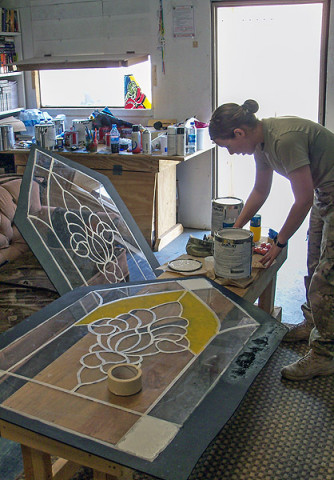 U.S. Army Spc. Erika Espeseth, chaplain’s assistant, 3rd Special Troops Battalion, 3rd Brigade Combat Team “Rakkasans, 101st Airborne Division (Air Assault), begins to paint one of ten plexiglass windows before they’re hung in the chapel on Forward Operating Base Salerno, Afghanistan. A team of chaplain’s assistants teamed up together to finish the restoration of their chapel after it was badly damaged by an attack on the FOB in the summer of 2012. (Courtesy photo provided by Spc. Erika Espeseth, chaplain’s assistant, 3rd Special Troops Battalion)