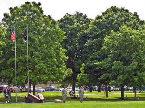 Soldiers prepare to assist Col. Scott Brower, commander of the 5th Special Forces Group (Airborne), in the laying of a wreath at one end of Gabriel Field in remembrance of the heroic service of the unit's fallen during a Memorial Ceremony May 18, 2013.  Gabriel Field was named in honor of Specialist 5 James P. Gabriel, who was one of the first Green Berets to be killed in Vietnam. It is memorialized with 57 markers placed around the perimeter of the field, each shadowed by an oak tree in remembrance of those who paid the ultimate sacrifice in training or combat operations. (Photo by Staff Sgt. Barbara Ospina) 