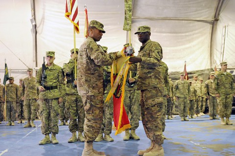 U.S. Army Col. Charles R. Hamilton, commander of the 101st Sustainment Brigade and Task Force Lifeliner and Command Sgt. Maj. Eugene J. Thomas Jr., unfurled the unit's colors during the transfer of authority ceremony June 8, 2013, at Bagram Airfield in Parwan province, Afghanistan. (U.S. Army photo by Sgt. Sinthia Rosario/Released)