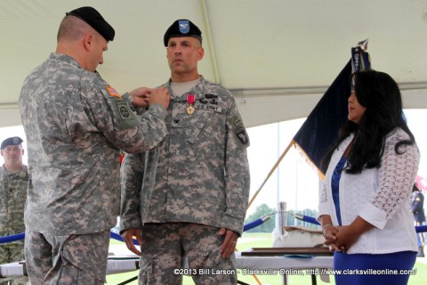Brig. Gen. Mark R. Stammer pins the Distinguished Member of the Regiment pin on Col. Daniel R. Walrath as Col. Walrath's wife Christine looks on.