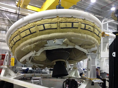A saucer-shaped test vehicle holding equipment for landing large payloads on Mars is shown in the Missile Assembly Building at the US Navy's Pacific Missile Range Facility in Kaua'i, Hawaii. (NASA/JPL-Caltech)