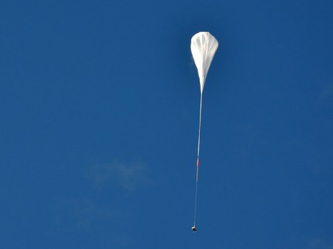 The test vehicle for NASA's Low-Density Supersonic Decelerator rides on a balloon to high altitudes above Hawaii. (NASA/JPL-Caltech)