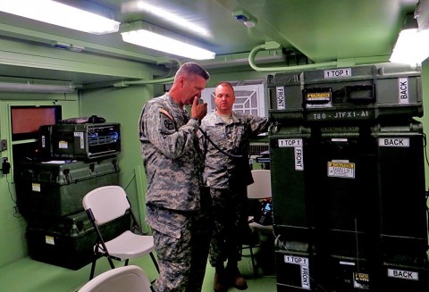 Brig. Gen. Jeffrey Holmes, Assistant Adjutant General, Army (Traditional,) contacts the Tennessee National Guard’s Joint Force Headquarters using the Joint Incident Site Communication Capability System’s or (JISCC) mobile communication assets. Master Sgt. Chris Davenport with Tennessee Guard’s Directorate of Information Management in Nashville, Tenn., assists Holmes operate equipment to communicate with leadership and emergency responders outside the simulated disaster area.
