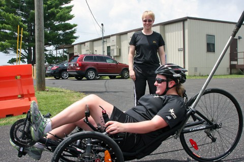 Spc. Amanda Lyle rides recumbent bicycle June 30, 2014 at Fort Campbell outside the Warrior Transition Battalion’s Adaptive Reconditioning Program office. Lyle recently wheeled her way to a silver medal in recumbent cycling at the Army Warrior Games trials June 15-20 at the U.S. Military Academy, West Point, New York. (U.S. Army photo by Stacy Rzepka)