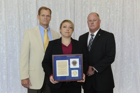 Chief Al Ansley, Officer Melissa Spielhagen, and Deputy Chief Mike Parr with the certificate of recognition for the City of Clarksville Police Department