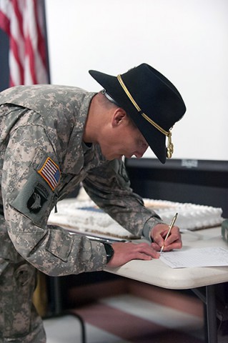 Lt. Col. Jack Murphy, commander, 2nd Squadron, 17th Cavalry Regiment, 101st Combat Aviation Brigade, 101st Airborne Division (Air Assault), signs paperwork to transfer an OH-58D Kiowa Warrior helicopter at Don F. Pratt museum, Fort Campbell, Ky., April 22, 2015. (Sgt. Duncan Brennan, 101st CAB Public Affairs)