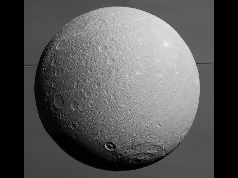 This view from NASA's Cassini spacecraft looks toward Saturn's icy moon Dione, with giant Saturn and its rings in the background, just prior to the mission's final close approach to the moon on August 17, 2015. (NASA/JPL-Caltech/Space Science Institute)