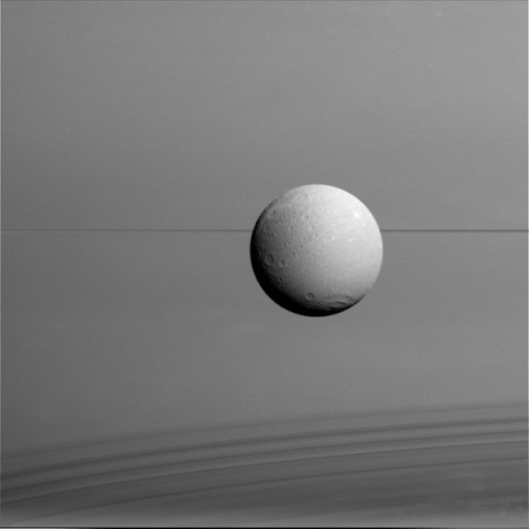 Dione hangs in front of Saturn and its icy rings in this view, captured during Cassini's final close flyby of the icy moon. (NASA/JPL-Caltech/Space Science Institute)