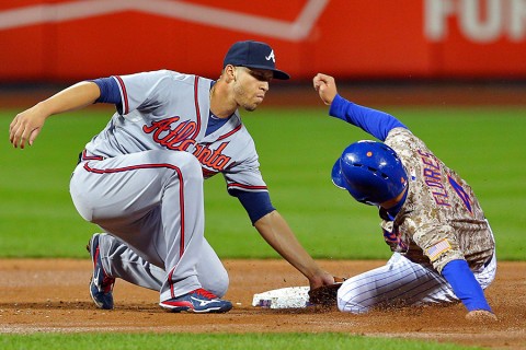 Atlanta Braves shortstop Andrelton Simmons (19) tags out New York Mets shortstop Wilmer Flores (4) on a steal attempt during the second inning at Citi Field. (Brad Penner-USA TODAY Sports)