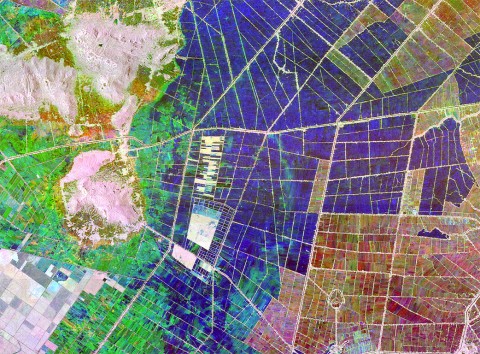 These two satellite images depict the An Giang Province in Vietnam’s Mekong Delta, a major rice-producing region, at different times of year. Dark blue and black areas are inundated and have low biomass, while white and gray areas are other crops like row crops and trees. The differences in color indicate a change in the ratio between soil moisture and biomass. (NASA)