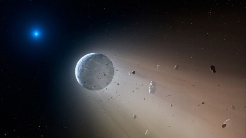 In this artist's conception, a tiny rocky object vaporizes as it orbits a white dwarf star. Astronomers have detected the first planetary object transiting a white dwarf using data from the K2 mission. Slowly the object will disintegrate, leaving a dusting of metals on the surface of the star. (CfA/Mark A. Garlick)