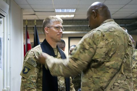 Master Sgt. Fredrick Murphy, right, master chaplain assistant, 101st Airborne Division (Air Assault) and Combined Joint Forces Land Component Command – Operation Inherent Resolve, adjusts the stole on Lt. Col. David Bowlus, outgoing 101st and CJFLCC-OIR chaplain, before a change of stole ceremony in Baghdad on May 30, 2016. (Sgt. Katie Eggers) 