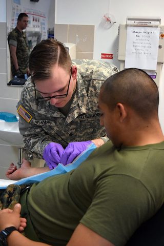 Specialist Bowman (center), a medic with the 230th Engineer Battalion, 194th Engineer Brigade, Tennessee Army National Guard, prepares to administer an IV during a medical training during Operation Resolute Castle on May 26, 2016 at Novo Selo Training Area, Bulgaria. As part of the exercise, Spc. Bowman was required to evaluate patients and administer IVs. (1st Lt. Matthew Gilbert, 194th Engineer Brigade)