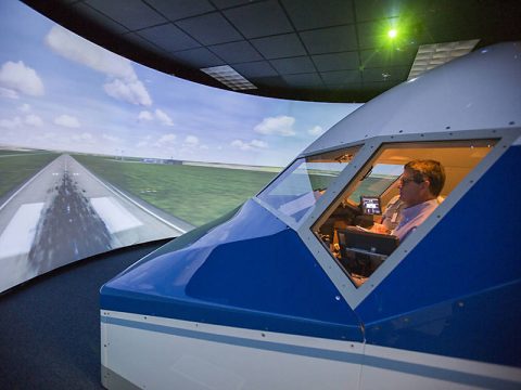 At NASA’s Langley Research Center, retired airline pilots test procedures that will be used during upcoming flight tests of a new aircraft spacing tool. The simulator is set up like a 757 jet, similar to one of the aircraft in the ATD-1 flight tests. (NASA Langley / David C. Bowman)