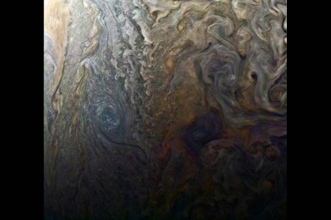 This enhanced-color image of a mysterious dark spot on Jupiter seems to reveal a Jovian "galaxy" of swirling storms. (NASA/JPL-Caltech/SwRI/MSSS/Roman Tkachenko)
