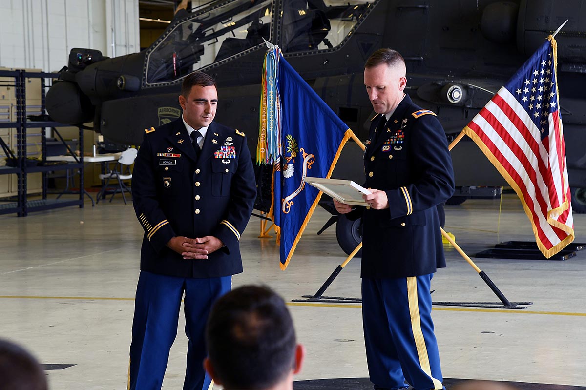 Col. Bernard Harrington, the commander of the 82nd Combat Aviation Brigade,  presents an award to Chief Warrant Officer 4 James Morrow, a flight  instructor from Fort Rucker, June 30, 2017 at Fort
