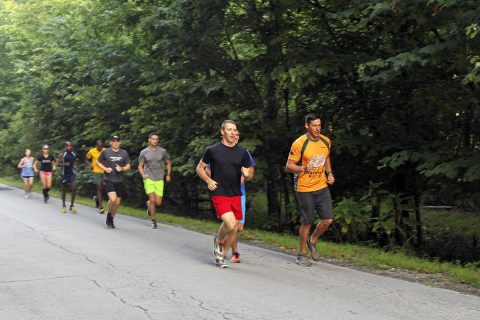 Capt. Josh Joseph (front right), commander for Headquarters and Headquarters Company, 101st Special Troops Battalion, 101st Airborne Division (Air Assault) Sustainment Brigade, 101st Abn. Div., and another member of the Fort Campbell, Kentucky Ten Miler Team, lead a group of runners, Aug. 3, 2017, during practice trail run on Fort Campbell, Kentucky. (Sgt. Neysa Canfield, 101st Sustainment Brigade, 101st Airborne Division (AA) Public Affairs)
