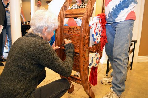 Betty Tidwell, writes a message on the rocking horse honoring her late son Sgt. 1st Class Tony Knier, during a presentation ceremony at the Fort Campbell Fisher House Oct. 13. The rocking horse is meant to bring joy to children staying at the Fisher House, while honoring Knier who was killed in Bayji, Iraq in 2006. The rocking horse is one in a series honoring fallen service members donated to Fisher Houses across the nation. (Maria Yager)