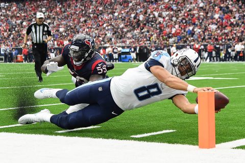 Tennessee Titans quarterback Marcus Mariota (8) scores a touchdown ahead of Houston Texans outside linebacker Whitney Mercilus (59) during the second quarter at NRG Stadium Oct. 1, 2017. (Shanna Lockwood-USA TODAY Sports)