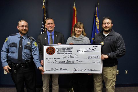 Montgomery County Sheriff John Fuson, Deputy Chad O’Brien, and Investigator Ryan Ayrest present a check to Jackie Proffit with St. Jude’s Entertainment Marketing for $4,060.