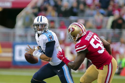 Tennessee Titans quarterback Marcus Mariota (8) scrambles with the ball against San Francisco 49ers defensive end Elvis Dumervil (58) during the third quarter at Levi's Stadium. (Sergio Estrada-USA TODAY Sports)